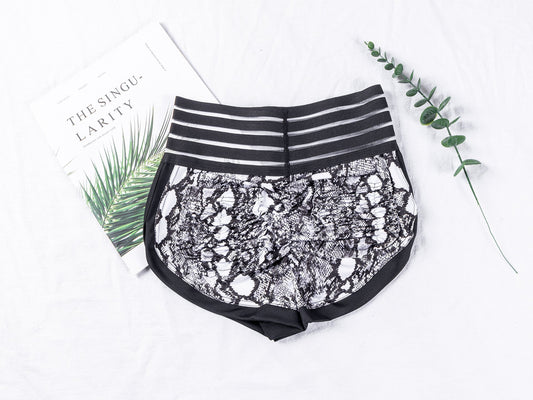 Black lace shorts with striped waistband on a white background
