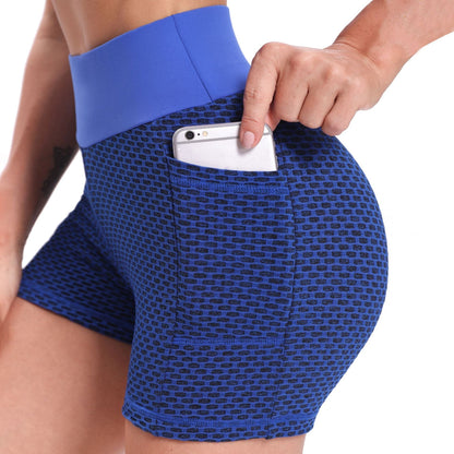 Blue patterned shorts with a pocket holding a phone on a white background