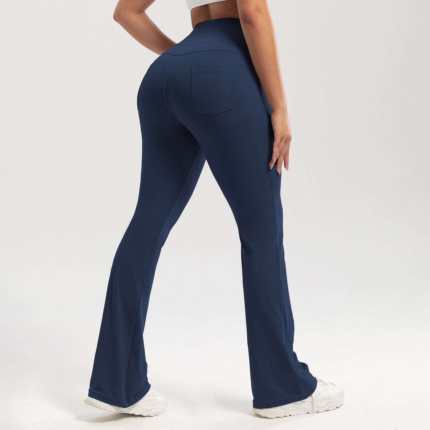 Navy blue pants worn by a person on a white background