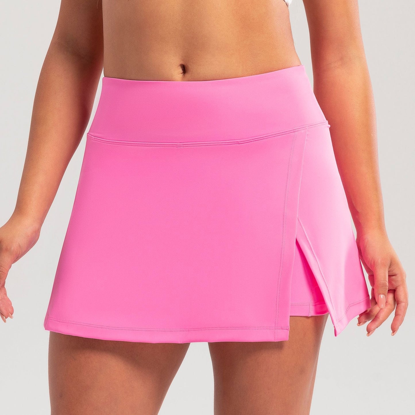 Pink skirt worn by a person on a plain background