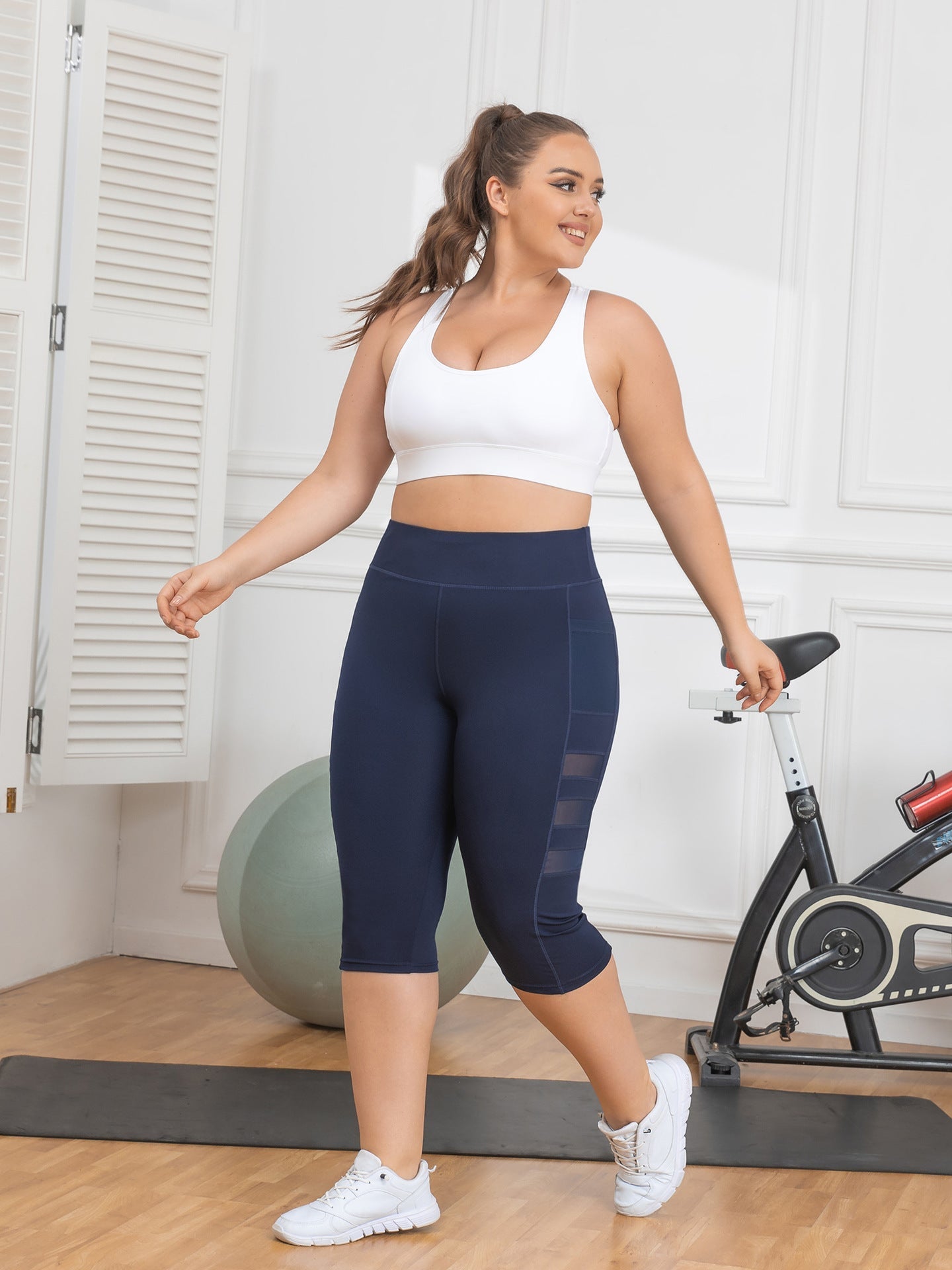 Woman in athletic wear standing in a home gym setting